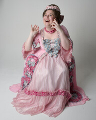 Full length portrait female model wearing opulent pink gown costume of historical French baroque...
