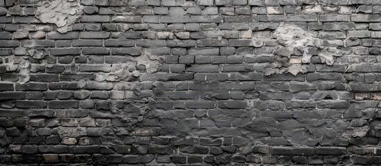 A black and white photo showcasing a grungy grey brick wall, creating an edgy and urban background.