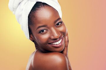 Portrait, smile and black woman with hair towel in studio for skincare, wellness or body care on...