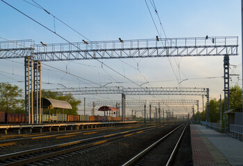 View of the railway and infrastructure and power lines at sunset