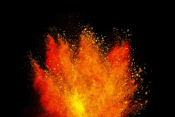 Fototapeten Abstract powder splatted background. Colorful powder explosion on black background. Colored cloud. Colorful dust explode. Freeze motion of orange color powder exploding  © piyaphong