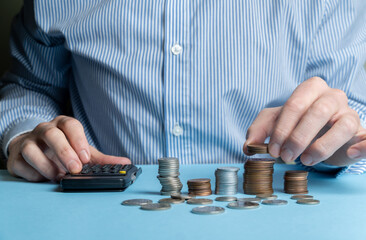 Businessman stacking coins representing rising financial and business interest rate. Concept of...