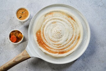Dosa placed on a non stick ceramic  griddle tawa | Pancake crepe pan
