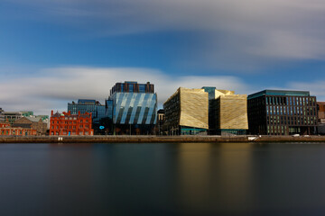 Dublin, Ireland, Dockland, modern building business center cityscape by Liffey river view during sunny day in background. europe