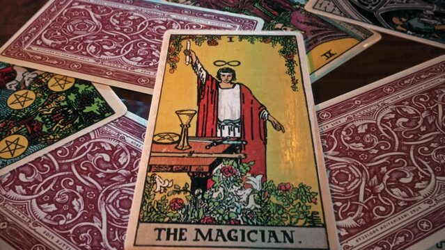 Madrid, Spain - April 12, 2011. Ancient esoteric fortune telling ritual of reading magic tarot card deck. Ancient esoteric divination predicting fortune. Ancient esoteric tradition divinating fortune