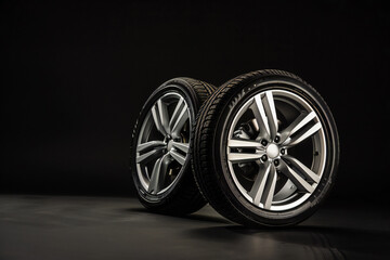 Studio shot of a set of summer economy car tires. Car tire store, discounts on tires, car tire store banner