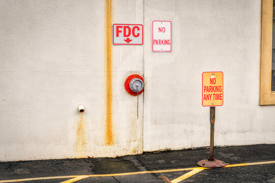 A parking space is blocked off as No Parking due to this side of the building having attachments for the Fire Department in case of fire.  No parking along building in Vestal in Upstate NY.