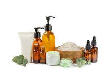 Beautiful spa composition with eucalyptus leaves isolated on white background. Beauty and fashion spa concept with body cream, scrub, mask, essential oil and sea salt.Cosmetic product.
