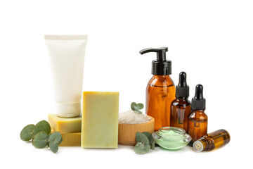 Beautiful spa composition with eucalyptus leaves isolated on white background. Beauty and fashion spa concept with body cream, scrub, mask, essential oil and sea salt.Cosmetic product.