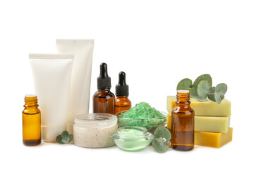 Beautiful spa composition with eucalyptus leaves isolated on white background. Beauty and fashion spa concept with body cream, scrub, mask, essential oil and sea salt.Cosmetic product.