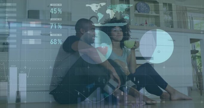 Animation of data processing over diverse couple sitting on kitchen floor drinking tea