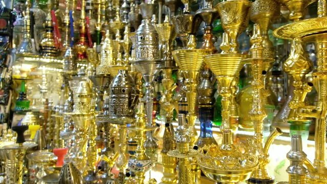 Shining waterpipes at souvenir shop. Rows of hookahs at market. Narghiles for sale at traditional middle eastern market. Khan El Khalili market, Cairo, Egypt