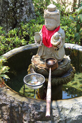 statue of a divinity in a buddhist temple in miyajima in japan 