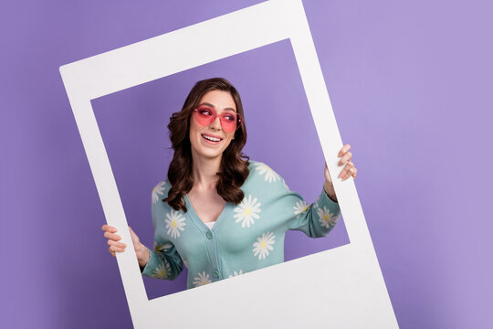Photo of cute funky woman wear cardigan pink heart shape glasses tacking photo looking empty space isolated purple color background