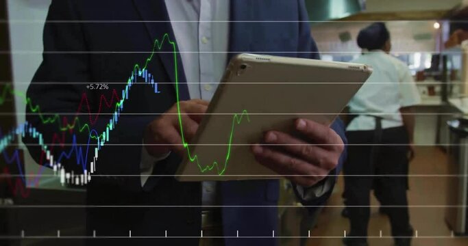 Animation of financial data processing over businessman using tablet