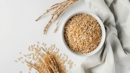 brown rice on the white background, top view - obrazy, fototapety, plakaty