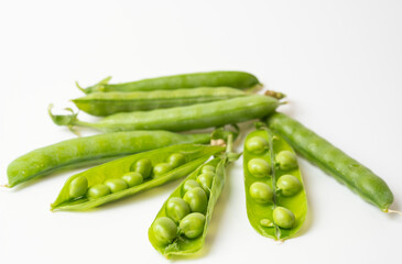 Ripe green peas on a white background.