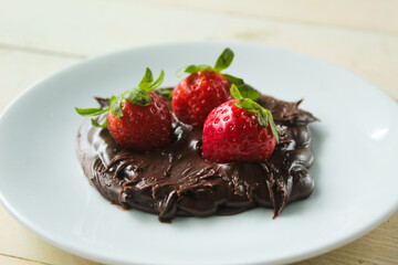 strawberries dipped in chocolate, on a white plate