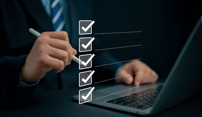 Check list concept.Businessman using laptop with online checklist survey, filling out digital form...