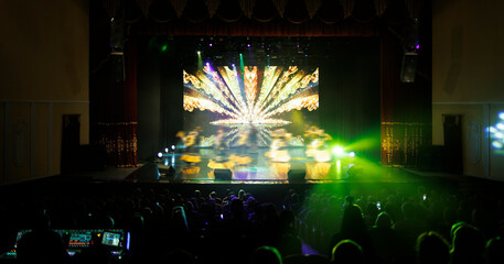 Obraz premium Сoncert on scene theater, stage light with colored spotlights and smoke.
