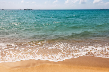 Empty sea beach with sand, view to azure waves. Background for holidays on a paradise nature