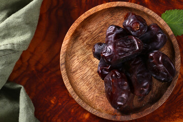 organic natural dried dates in a wooden plate