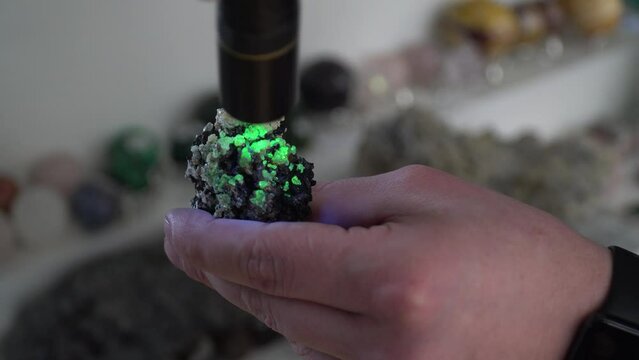 glowing stone. Opal. The stone glows under ultraviolet light. Geology. Geologic findings. Excavation. Rare stone. Rock.