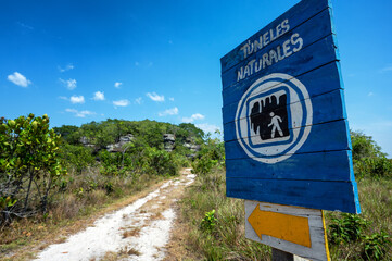Sign pointing towards Los Tuneles near San Jose del Guaviare, Colombia