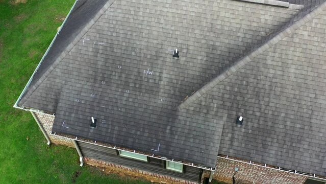 Roof with hail damage and markings from inspection