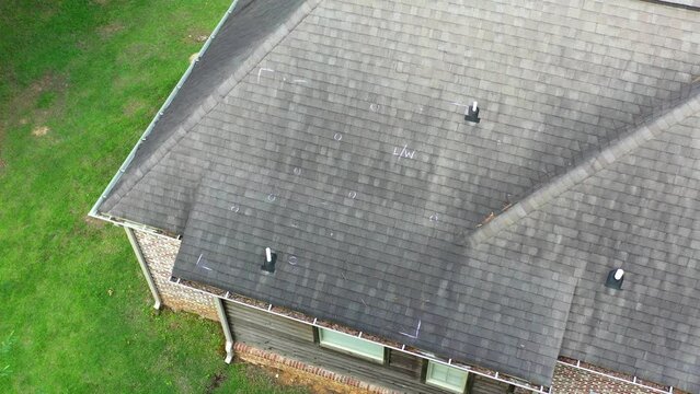 Roof with hail damage and markings from inspection