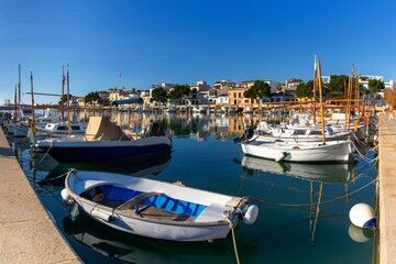 colourful fishing boats and the historic waterfront of Portocolom in eastern Mallorca