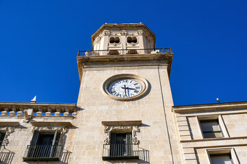 Fototapeta na wymiar Low angle view of clock tower in medieval facade of the City Hal