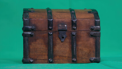 Vintage Wooden Treasure Chest on Green Background