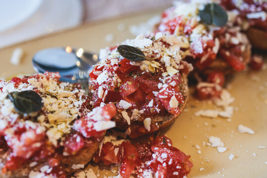 Cretan Ntakos on a plate in a greek cafe taverna, Dakos salad, barley rusks bread with tomatoes and feta cheese, traditional greek dish on a plate, Crete Island, Greece