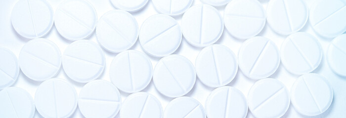 White tablets on a white background. Background of white round medical tablets