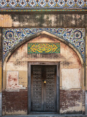 A wooden door at historic landmark Masjid Wazir Khan, a 17th-century Mughal mosque located in the city of Lahore, Punjab, Pakistan.