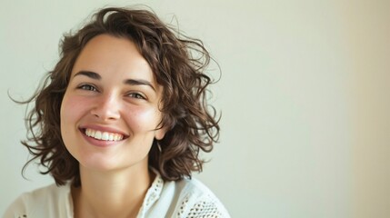 Captivating woman showcasing diverse smiles against a light toned background with ample copyspace