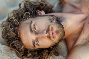 Naklejka premium Attractive topless male model on sand at beach