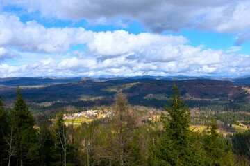 Fototapeta na wymiar View of forested landscape of Notranjska, Slovenia and a village near Logatec