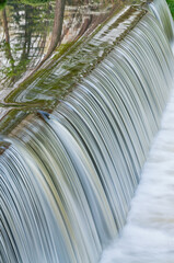 Landscape of the Portage Creek cascade captured with motion blur and with reflections of spring...