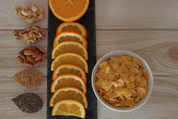 desayuno sano cereales naranja frutos secos semilllas chia lino  - obrazy, fototapety, plakaty