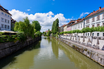 Fototapeta na wymiar Ljubljana, Slovenia - June 27, 2023: Waterfront of Ljubljanica River in Ljubljana, Slovenia.