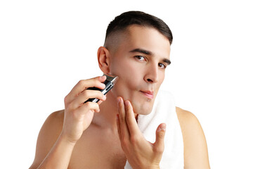 Handsome young man shaving face with electric razor on white background