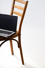 aptop. an open laptop is lying on a chair. a laptop and a chair on a white background