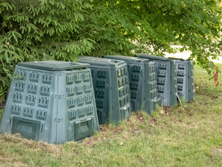 Big garden plastic composter bins in a garden in backyard outdoors