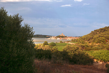 Distant view of Gruissan village, Tour de Barbarousse (Redbeard's Tower) and l'Étang de Gruissan from l'Île Saint Martin, on the Mediterranean coast of Southern France