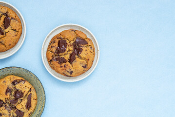 A piece of homemade chocolate chip cookie on ceramic plate.