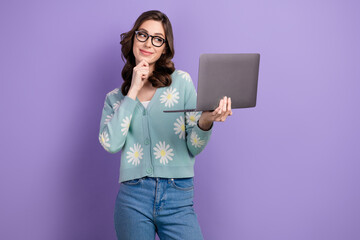 Photo of clever thoughtful young it specialist touch chin using laptop planning strategy on market...