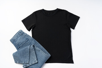 Cotton T-shirt and jeans on gray background top view