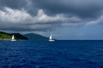sea ships on the blue sea on a sunny day near the Seychelles